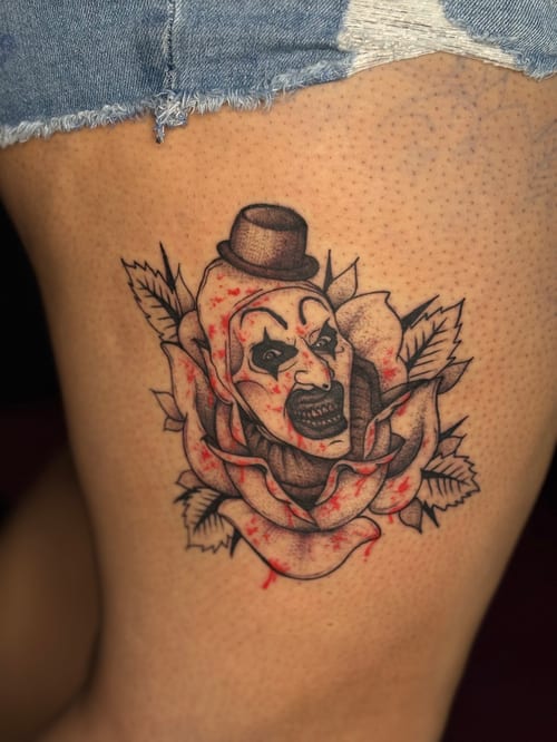 neo-traditional clown face with rose tattoo — by Dead Pretty Tattoos, los angeles