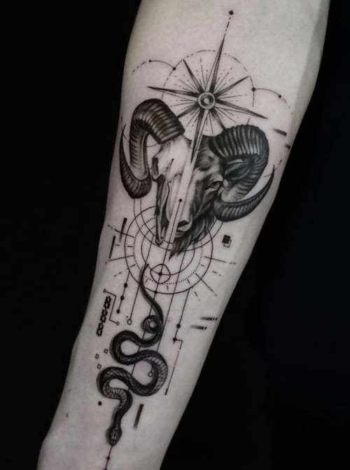 A black and grey tattoo on the forearm featuring a ram skull with geometric elements and a snake, rendered in a blackwork and dotwork style — by Jian Liang, los angeles