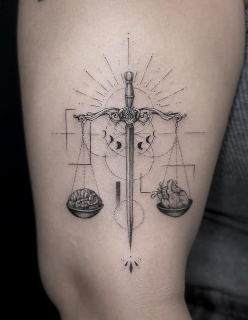 A fine line black and grey tattoo on the arm depicting a sword balanced with a brain and heart, surrounded by geometric patterns and moon phases — by Jian Liang, los angeles