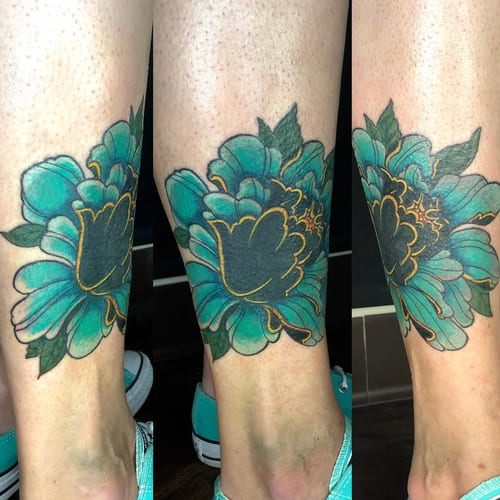 A bold and colorful neo-traditional flower tattoo on the calf with graphic outlines and vibrant colors — by Sandra Price, los angeles