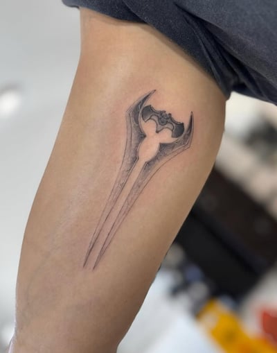 A minimalist black and grey sword tattoo on the arm with clean lines and subtle shading — by otaybeatdown, los angeles