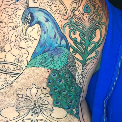 A colorful illustrative peacock tattoo on the side, featuring ornate details and vibrant feathers — by Sandra Price, los angeles