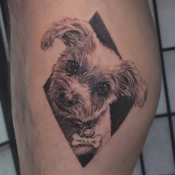A realistic black and grey dog portrait tattoo on the thigh, capturing fine details and shading — by Miguel ANGELO, temecula, ca