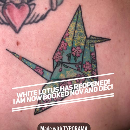 A colorful origami crane tattoo with floral patterns, showcasing a whimsical and delicate illustrative style — by Sandra Price, los angeles