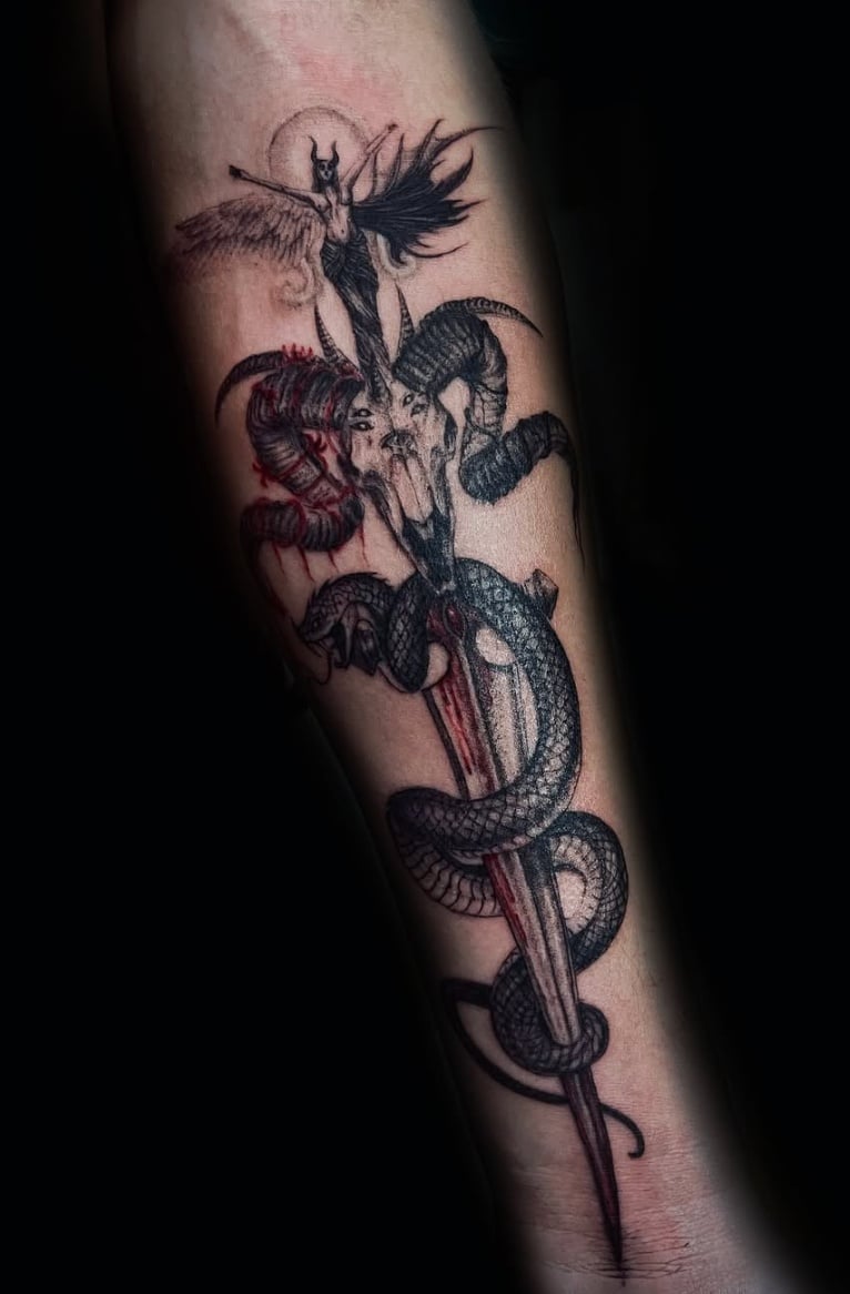 An illustrative tattoo on the forearm featuring a snake entwined around a dagger with a demon-like figure, using a mix of black and red ink for dramatic effect — by zitronxus, los angeles