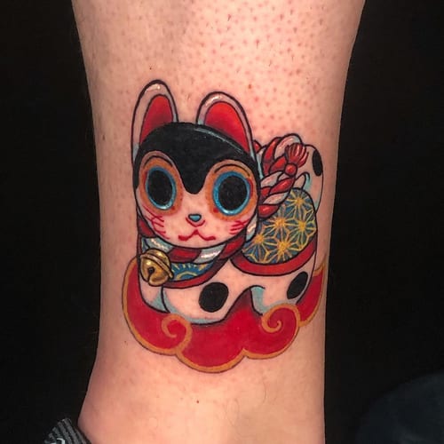 A colorful neo-traditional lucky cat tattoo on the forearm with bold outlines and Japanese elements — by Sandra Price, los angeles