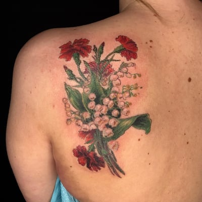 A realistic color flower bouquet tattoo on the shoulder, featuring delicate floral details and vibrant colors — by Sandra Price, los angeles