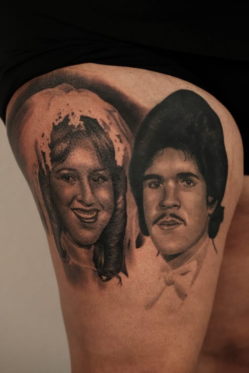 A black and grey realism portrait of a man and a woman on the thigh, capturing detailed facial features and expressions — by Johnny Ayala, los angeles