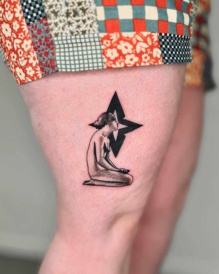 A minimalist blackwork tattoo of a sitting woman with a star on the thigh, featuring clean lines and simple shading — by Dylan Aiello, los angeles