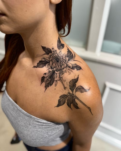 A delicate black and grey chrysanthemum tattoo on the shoulder and neck, featuring detailed floral design — by otaybeatdown, los angeles