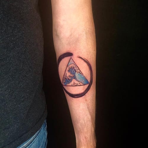 A colorful geometric wave tattoo inside a triangle on the forearm, featuring watercolor effects and clean lines — by Sandra Price, los angeles