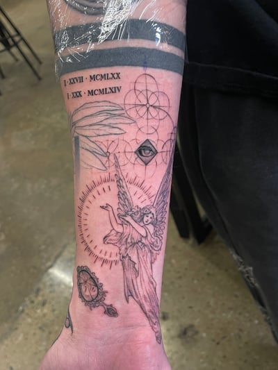 A black and grey fine line tattoo on the forearm featuring an angel, sacred geometry, and Roman numerals with intricate details — by Vince Espinoza, los angeles