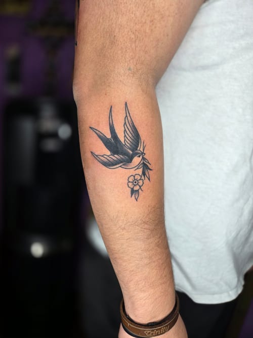 blackwork bird with flower tattoo — by ashynucklestattoo, los angeles