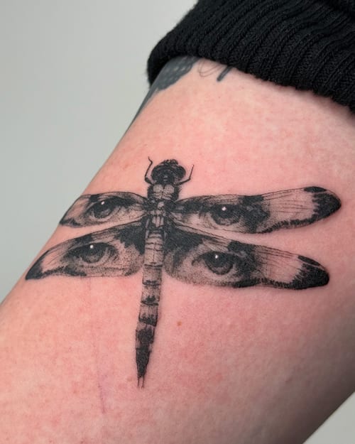 blackwork dragonfly with eyes tattoo — by Level tattoo, los angeles