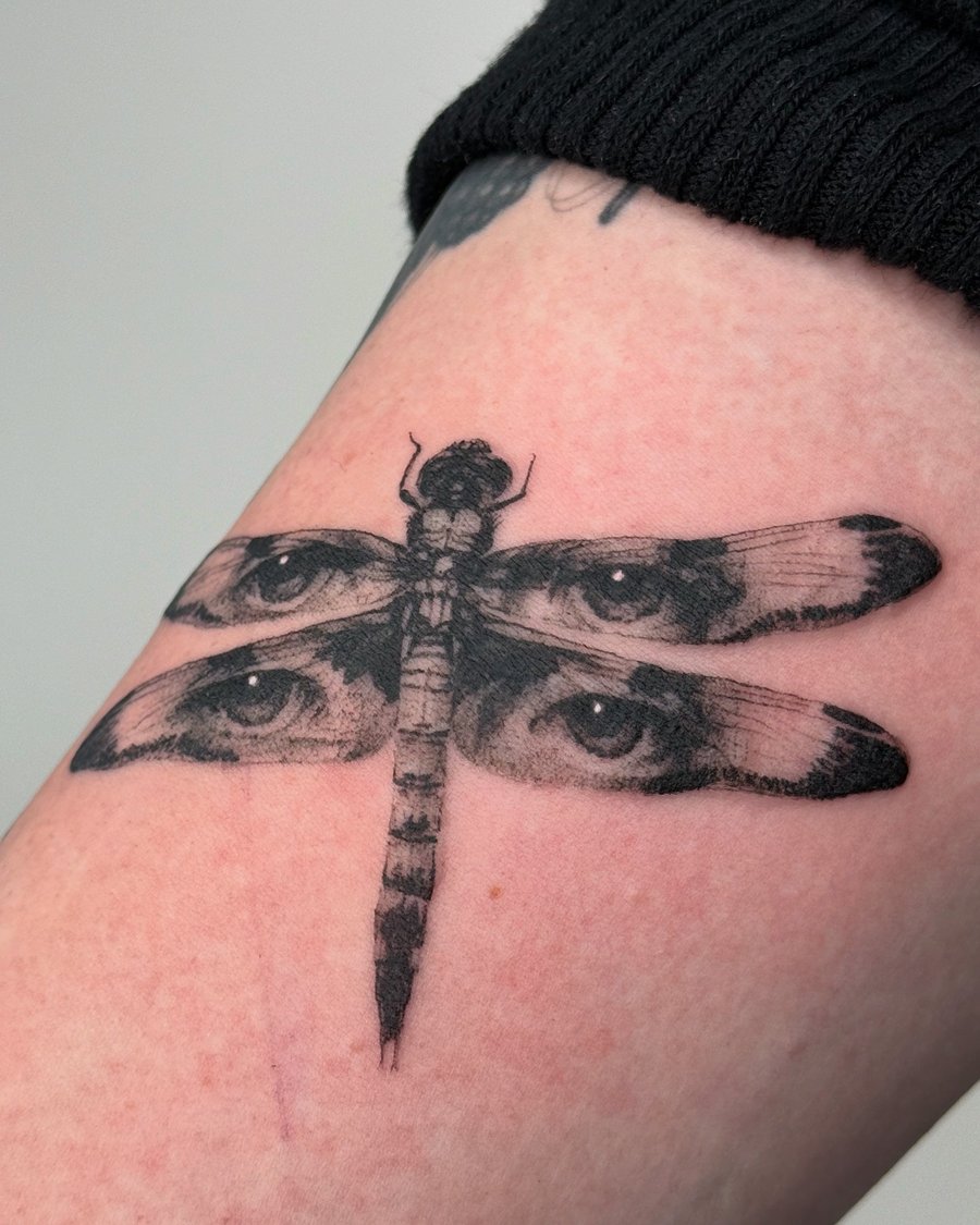 blackwork dragonfly with eyes tattoo — by Level tattoo, los angeles