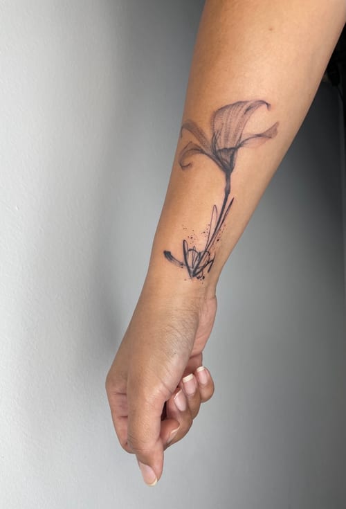 A fine line black and grey flower tattoo on the forearm with delicate shading and minimalistic design — by Brian Kies, los angeles