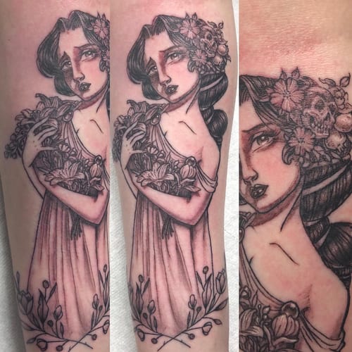 A black and grey illustrative tattoo of a woman holding flowers on the forearm, featuring ornate and romantic details — by Sandra Price, los angeles