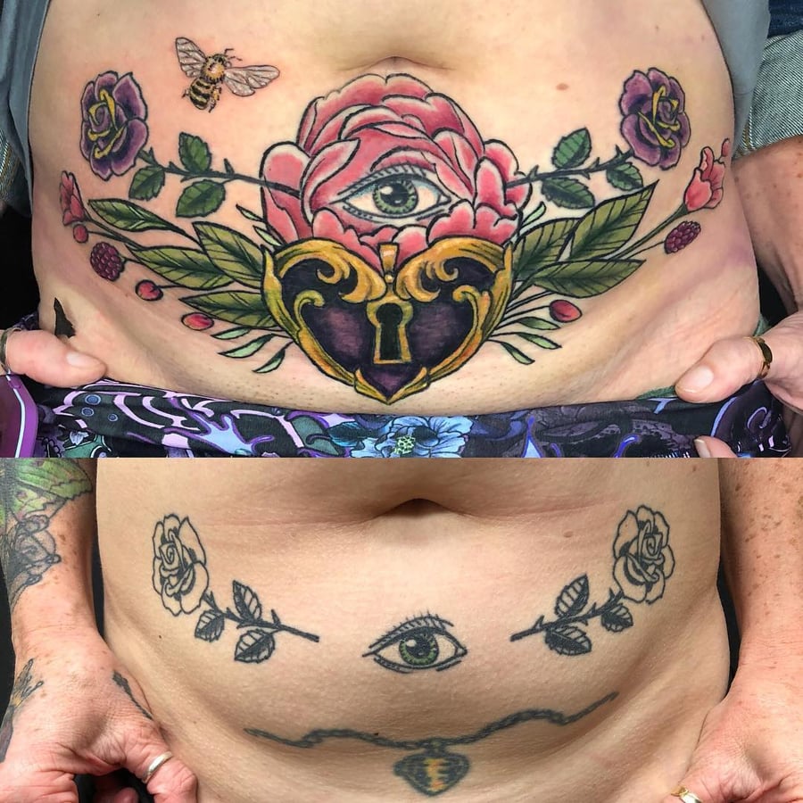 A bold neo-traditional tattoo on the stomach featuring an eye surrounded by roses and a heart-shaped lock in vibrant colors — by Sandra Price, los angeles