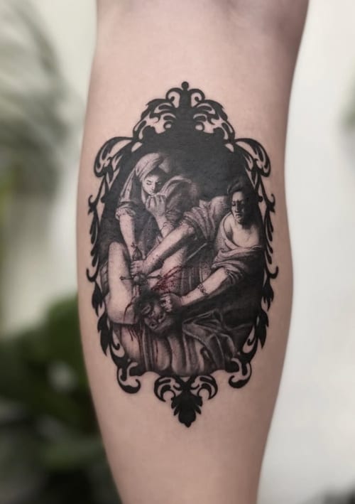 A black and grey realism tattoo depicting a dramatic religious scene on the forearm, framed with ornamental details — by Jian Liang, los angeles