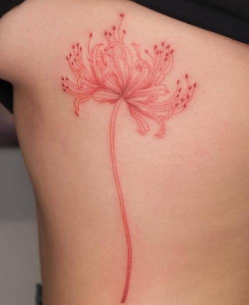 A delicate fine line tattoo of a red flower on the rib, featuring minimalist design and subtle details — by Samantha Wilks, los angeles