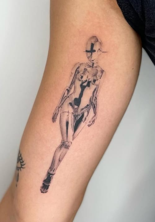 A fine line black and grey tattoo of a stylized woman on the arm, featuring intricate linework and abstract elements — by Level tattoo, los angeles