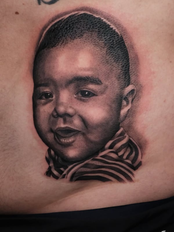 A realistic black and grey portrait of a child's face with detailed shading and texture — by Johnny Ayala, fontana, ca