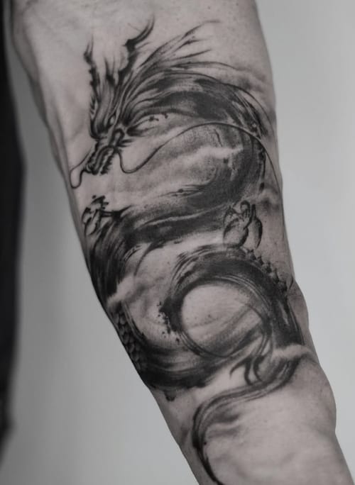 A black and grey Japanese-style dragon tattoo on the forearm, featuring dynamic lines and shading — by Jian Liang, los angeles