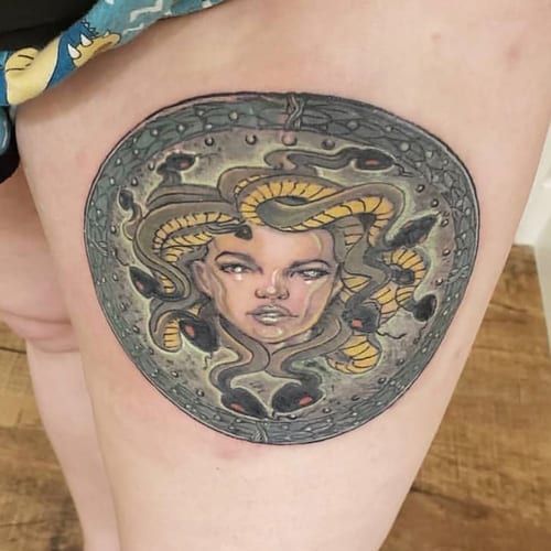 A bold and colorful Neo-Traditional Medusa tattoo on the thigh, featuring snakes and a mythological theme — by Sandra Price, los angeles