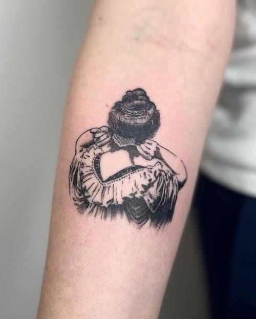 A black and grey linework tattoo of a woman embracing herself on the forearm, featuring intricate detailing and shading — by Level tattoo, los angeles