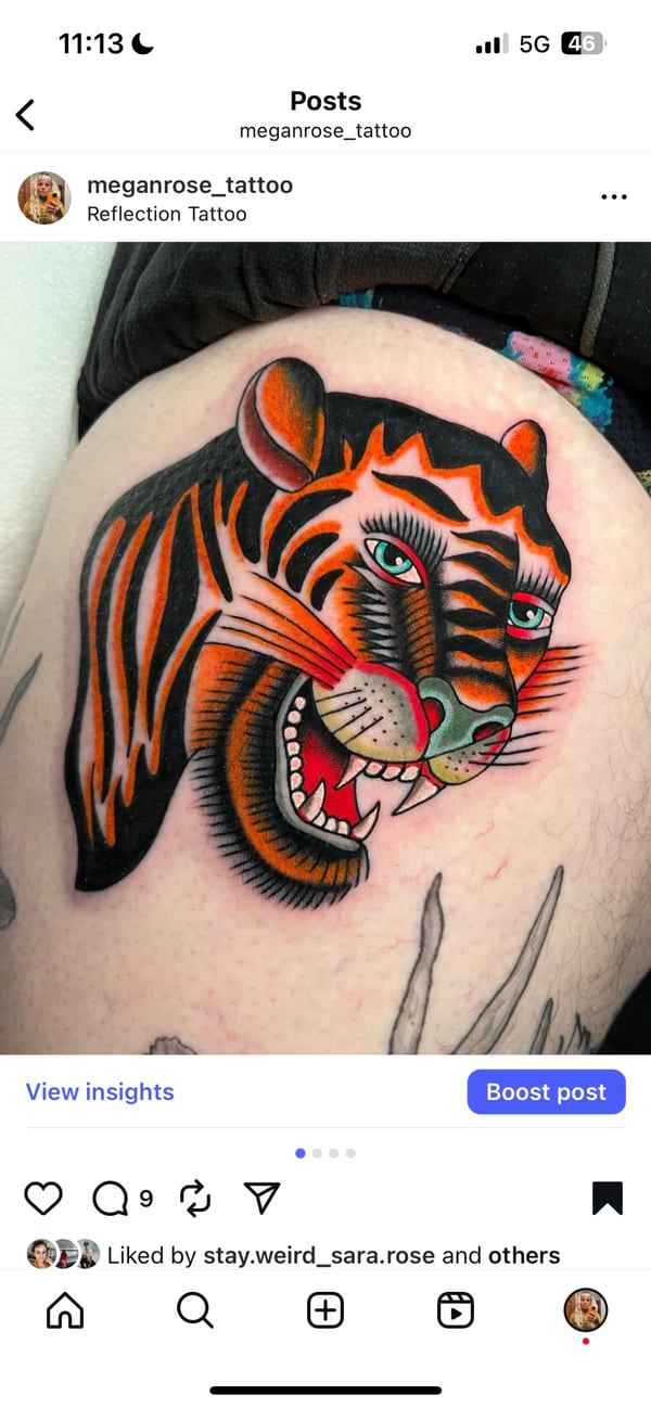 A vibrant Neo-Traditional tattoo of a tiger's head on the thigh, featuring bold lines and bright colors with an illustrative style — by Megan Rose, long beach, ca