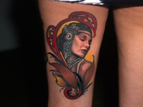 A colorful neo-traditional portrait of a woman on the thigh, featuring ornate details and vibrant colors — by Travis Ross, los angeles