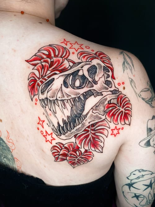 neo-traditional dinosaur skull with leaves tattoo — by katlyyons, los angeles