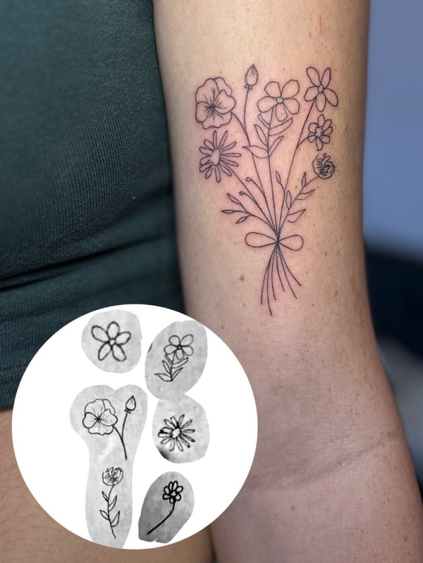 A delicate fine line floral bouquet tattoo on the arm in black and grey — by Maddie Ramirez, palm desert, ca