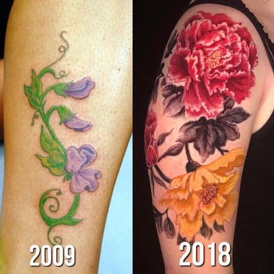 A bold and colorful floral tattoo on the upper arm, featuring large flowers in a watercolor style — by Sandra Price, los angeles