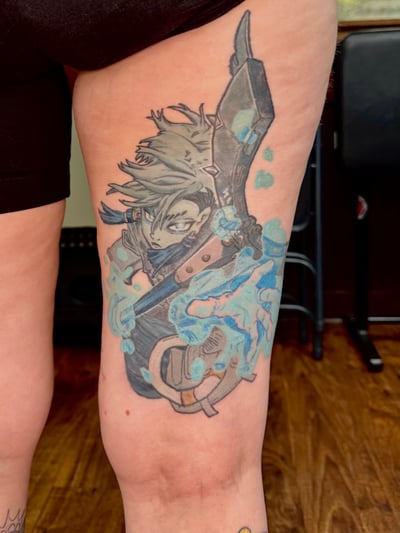 A colorful anime character tattoo on the thigh, featuring a sword and energy effects in a bold graphic style — by Sandra Price, los angeles
