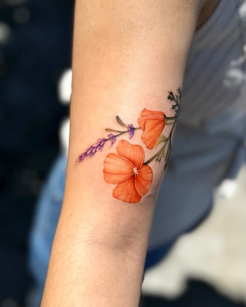 A colorful botanical tattoo on the forearm featuring orange flowers with delicate fine line details — by otaybeatdown, los angeles