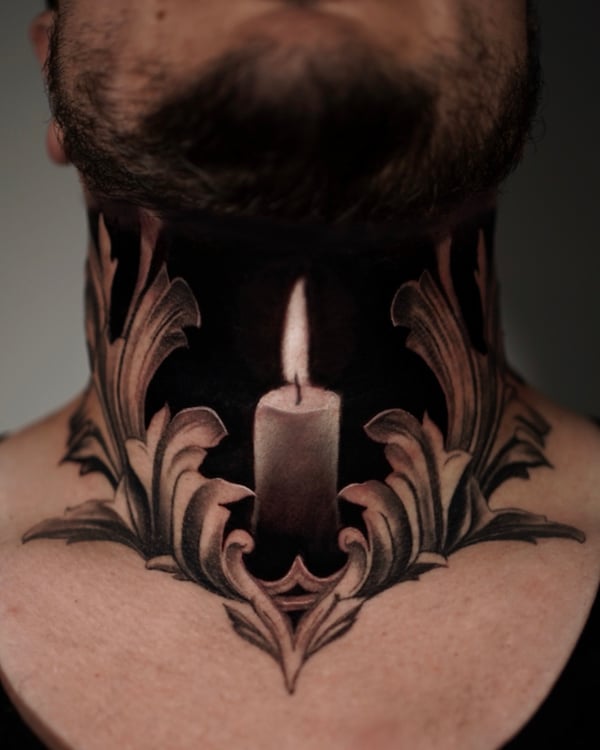 A black and grey tattoo of a candle with ornate designs on the neck, featuring intricate shading and dark tones — by Vladimir Kozachenko, los angeles