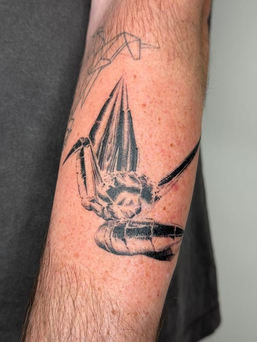 blackwork origami crane tattoo — by Level tattoo, los angeles