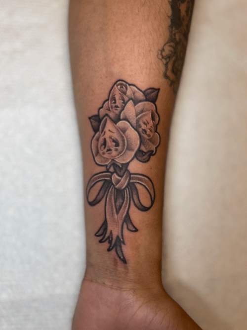 neo-traditional bouquet of roses with faces tattoo — by Engram, los angeles