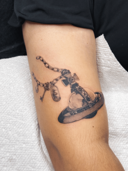 black & grey planet with cross tattoo — by lunayflorestattoo, los angeles