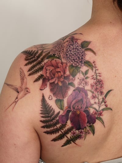 A colorful floral arrangement with a hummingbird on the shoulder, featuring realistic flowers and delicate details — by Melanie Benoit, los angeles
