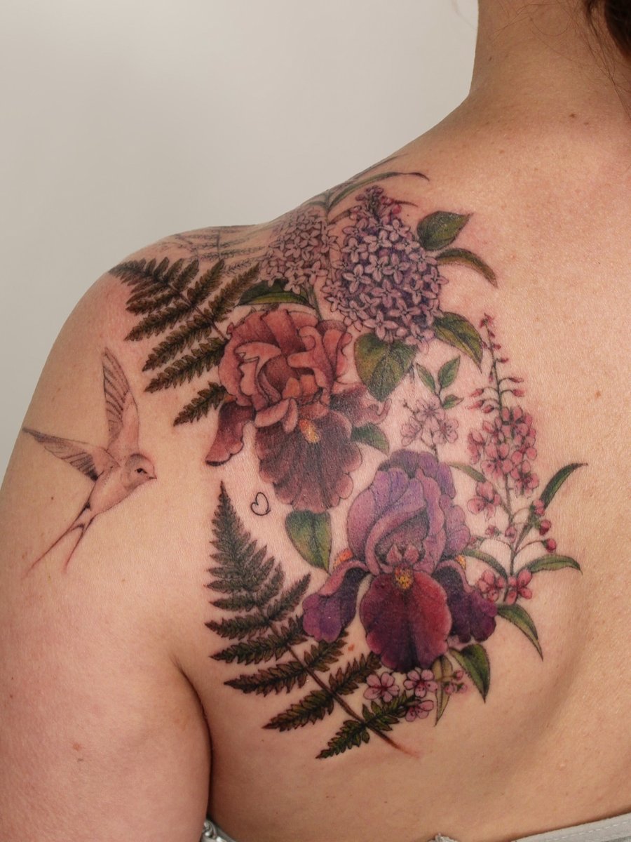 A colorful floral arrangement with a hummingbird on the shoulder, featuring realistic flowers and delicate details — by Melanie Benoit, los angeles