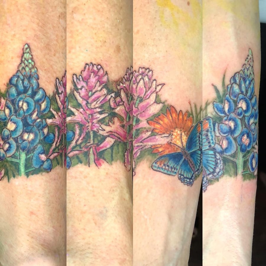 A colorful tattoo of wildflowers and a butterfly on the forearm, featuring realistic details and vibrant colors — by Sandra Price, los angeles