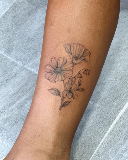 A delicate black and grey fine line flower bouquet tattoo on the forearm — by Melanie Benoit, los angeles