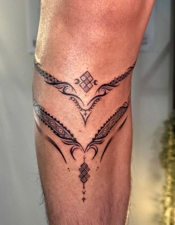 An ornamental blackwork tattoo on the leg featuring intricate geometric patterns and symmetrical designs — by NJ TATTOOZ, corona, ca