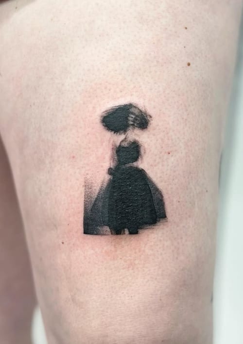 A minimalist blackwork tattoo of a woman in a dress on the thigh, featuring simple shapes and solid black shading — by Level tattoo, los angeles