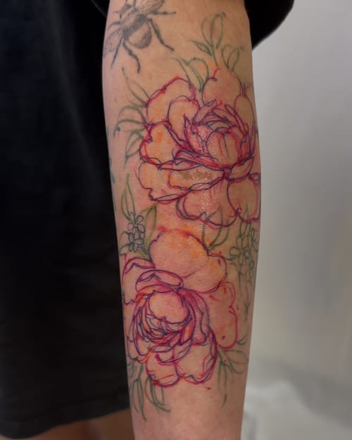 A delicate floral bouquet tattoo on the forearm with fine line work and colorful details — by Melanie Benoit, los angeles