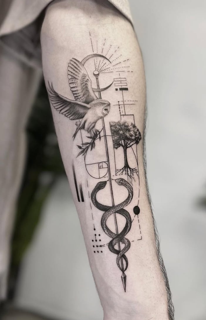 A black and grey tattoo on the forearm featuring a geometric design with a bird, tree, and snake intertwined with abstract elements — by Jian Liang, los angeles