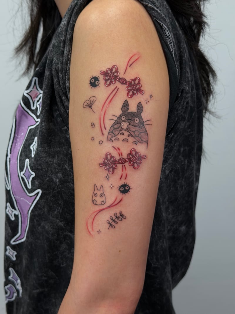 fine-line studio ghibli Totoro tattoo with soot sprites and red cherry-blossom accents by Rae Kaku, an anime tattoo artist in los angeles