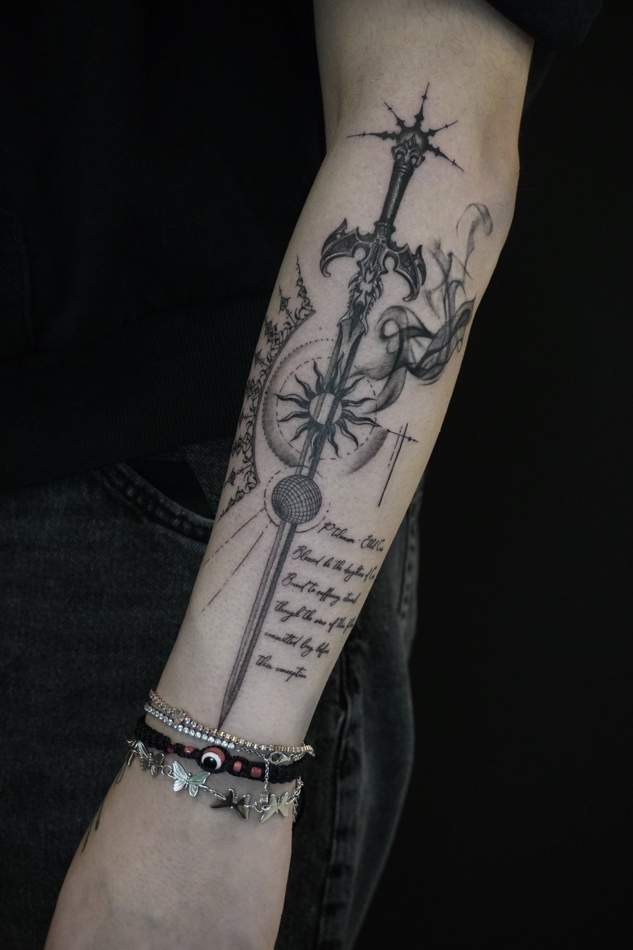 A black and grey illustrative sword tattoo on the forearm, featuring intricate details and script lettering — by Jian Liang, los angeles